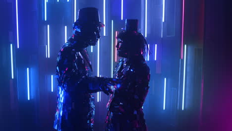 Two-robot-dancers-in-glittering-costumes-dance-against-a-neon-wall.